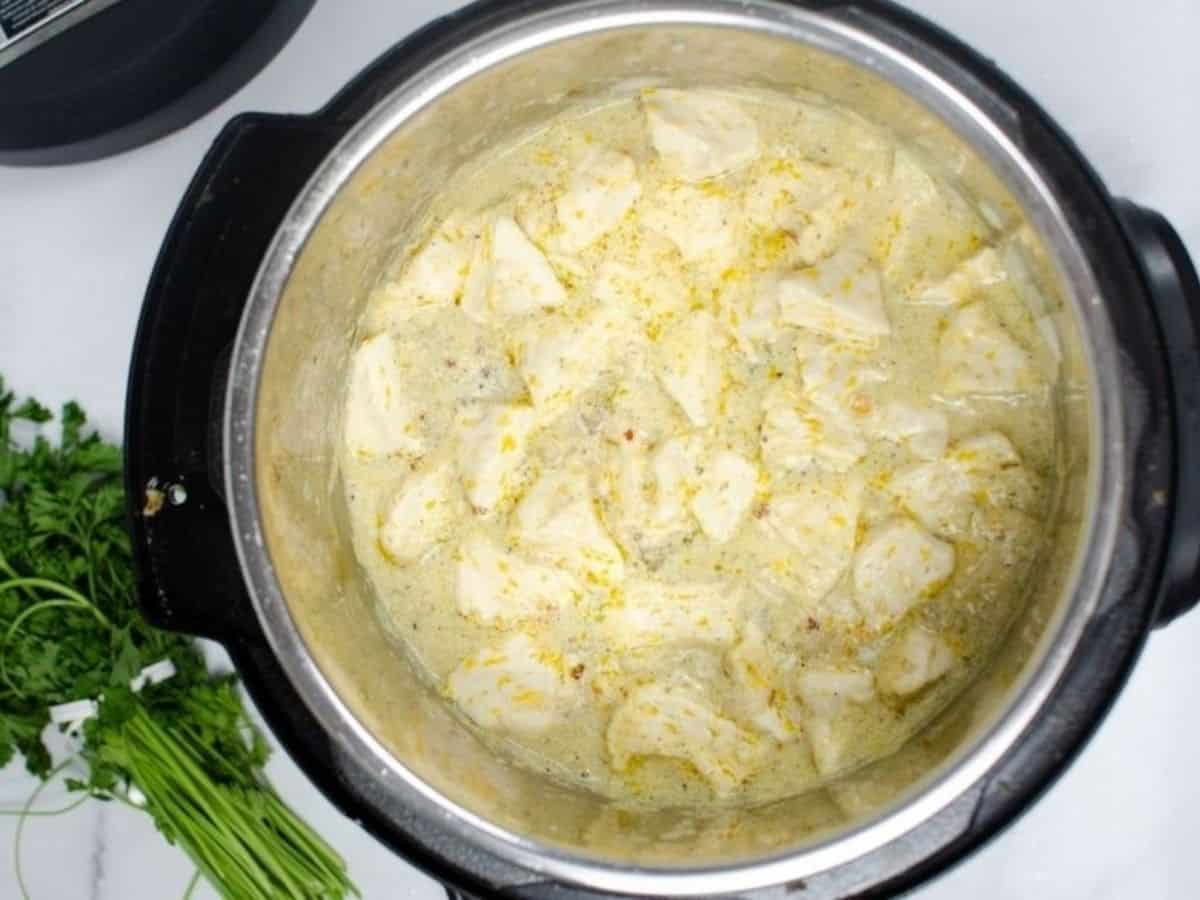 chicken and canned biscuit dumplings simmering in the Instant Pot