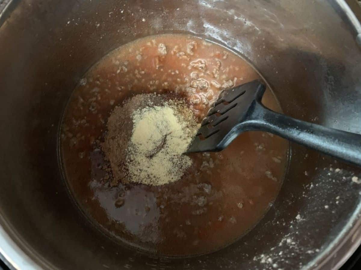 Ingredients for pressure cooker Cincinnati chili combined in the insert pot of the Instant Pot.
