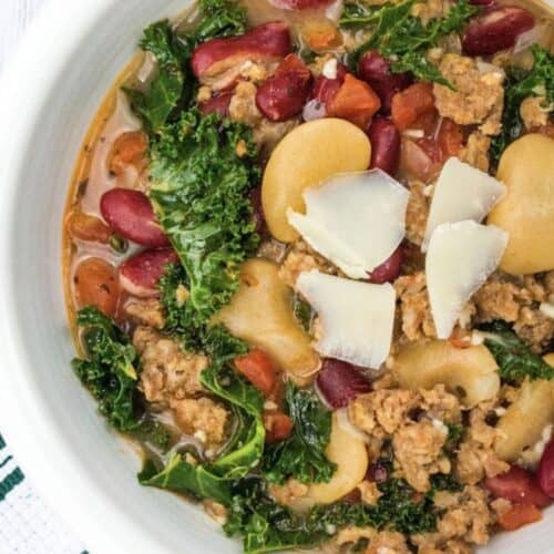 Instant Pot Italian sausage and bean soup served in a white bowl.
