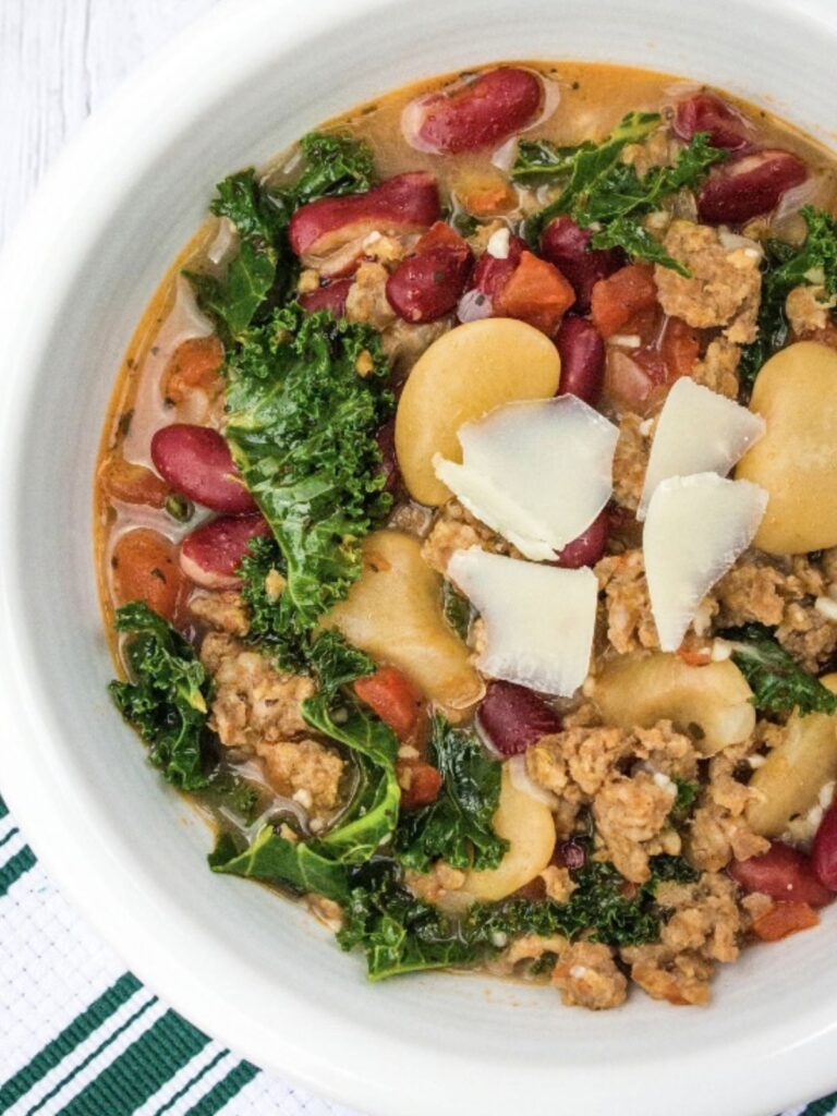 Instant Pot Italian sausage and bean soup served in a white bowl.
