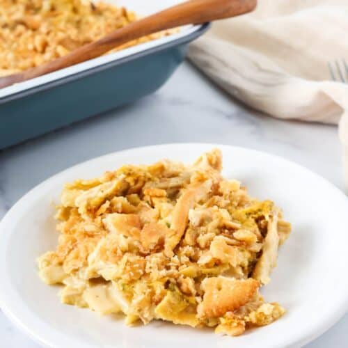 Knorr chicken noodle casserole served on a white plate, with a casserole baking dish in the background.
