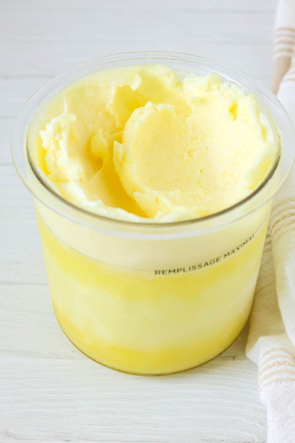 Ninja Creami pint container filled with lemon sorbet made with lemonade.