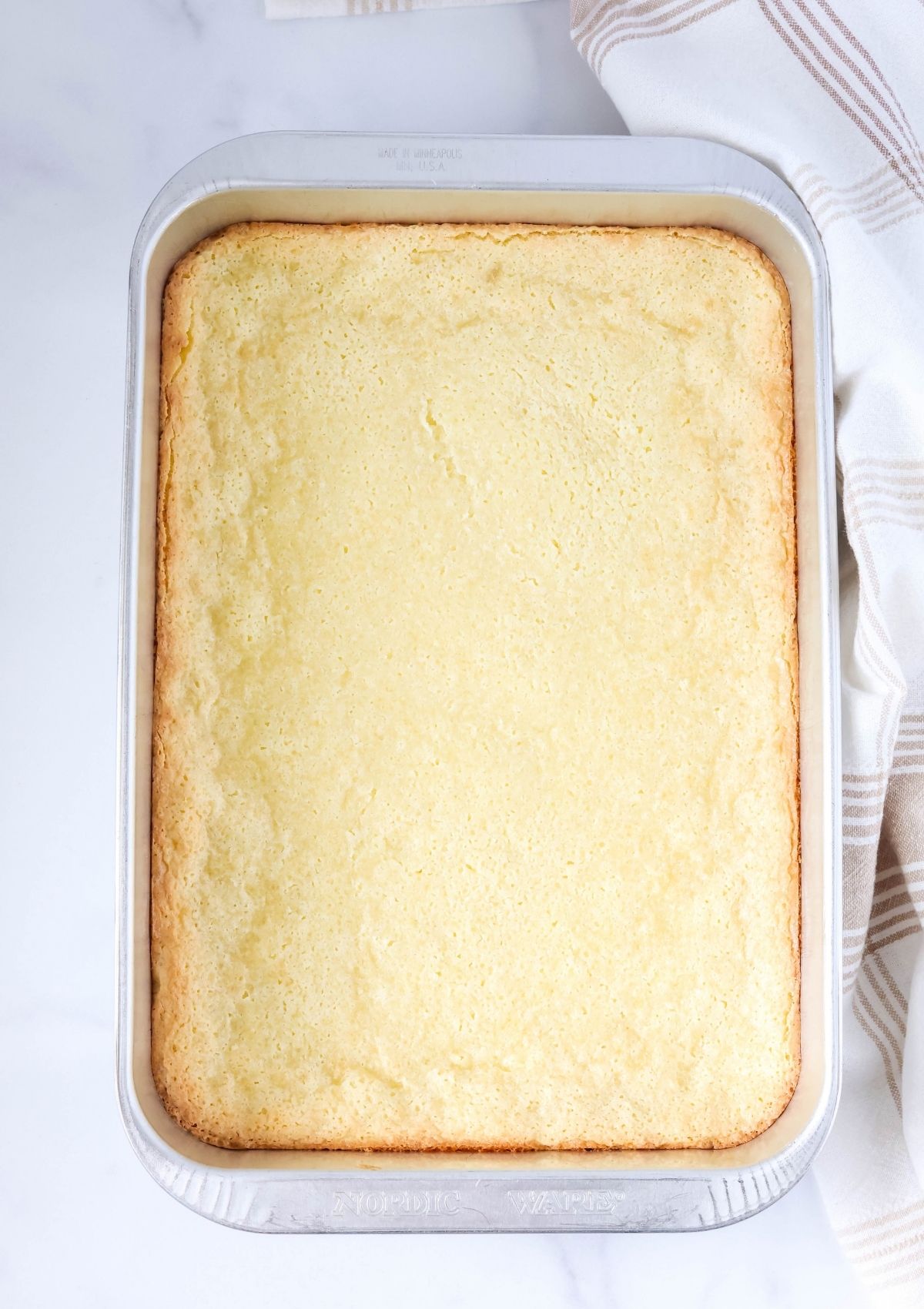 Overhead view of a freshly baked pan of ooey gooey butter cake.