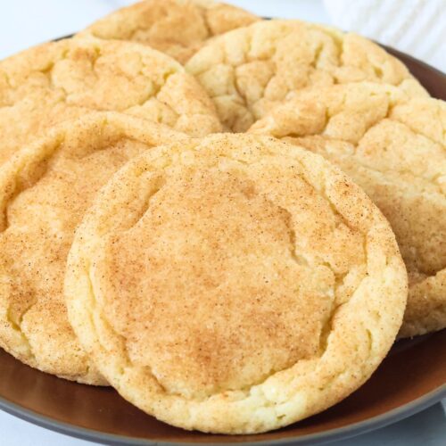 Snickerdoodle cookies displayed on a brown plate.