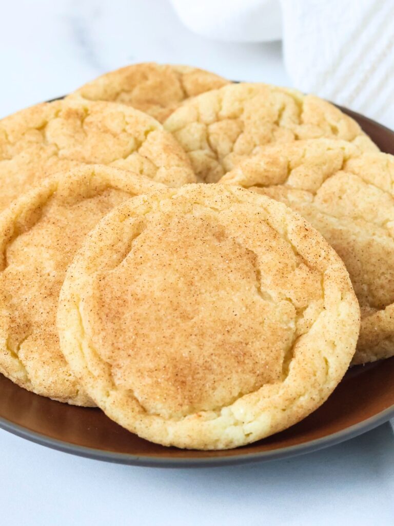 Snickerdoodle cookies displayed on a brown plate.