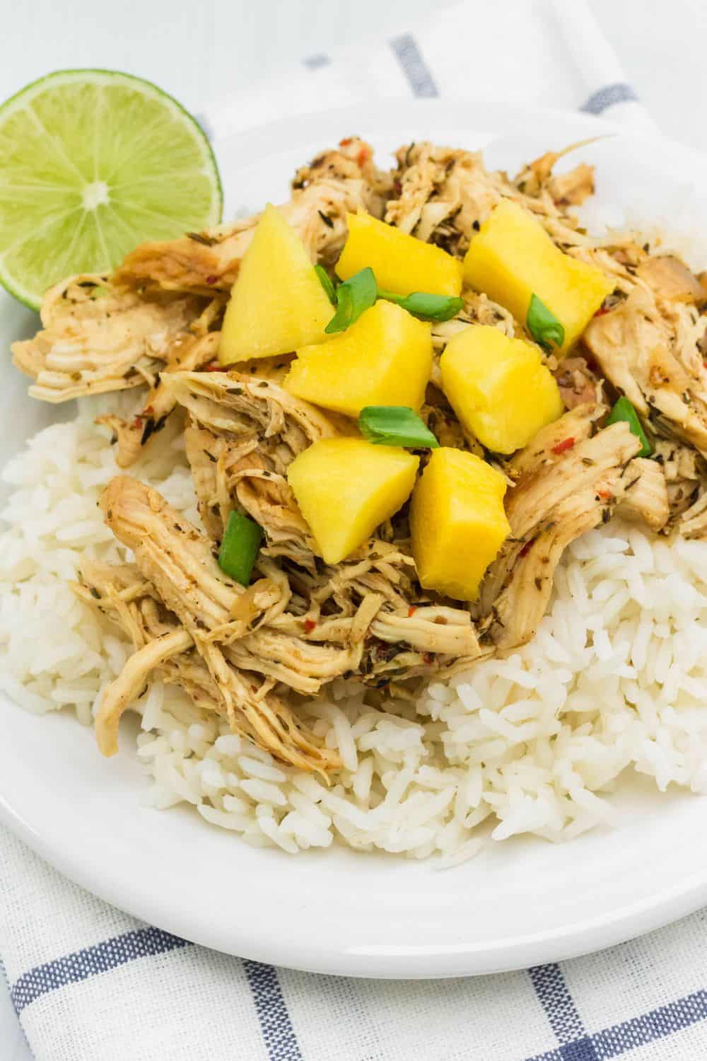 Jerk chicken and white rice topped with diced mango for a low-fat dinner.