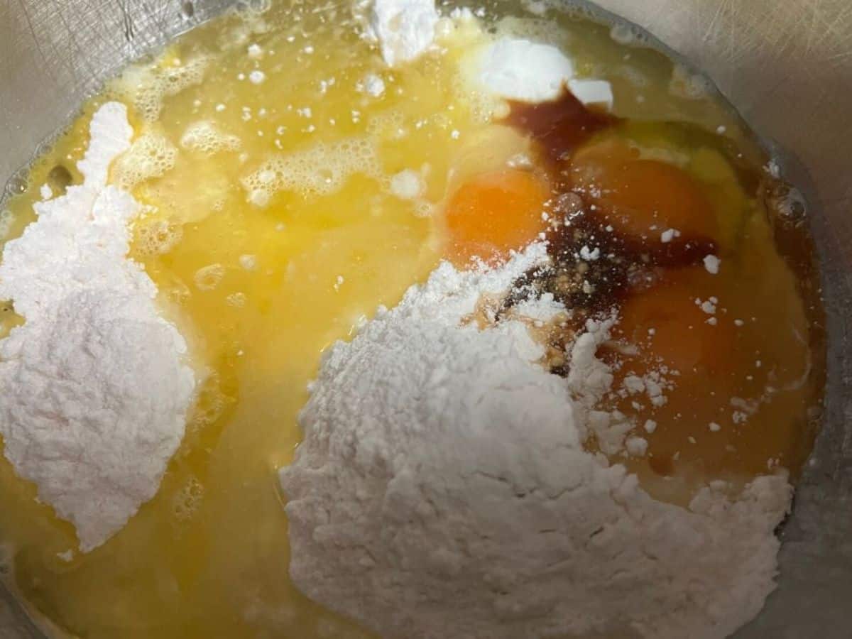 french vanilla cake ingredients added to a mixing bowl