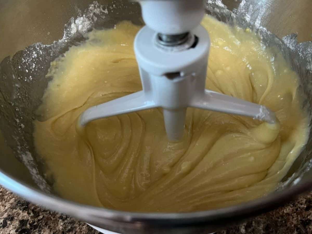 mixed cake batter in a mixing bowl for making a vanilla bundt cake